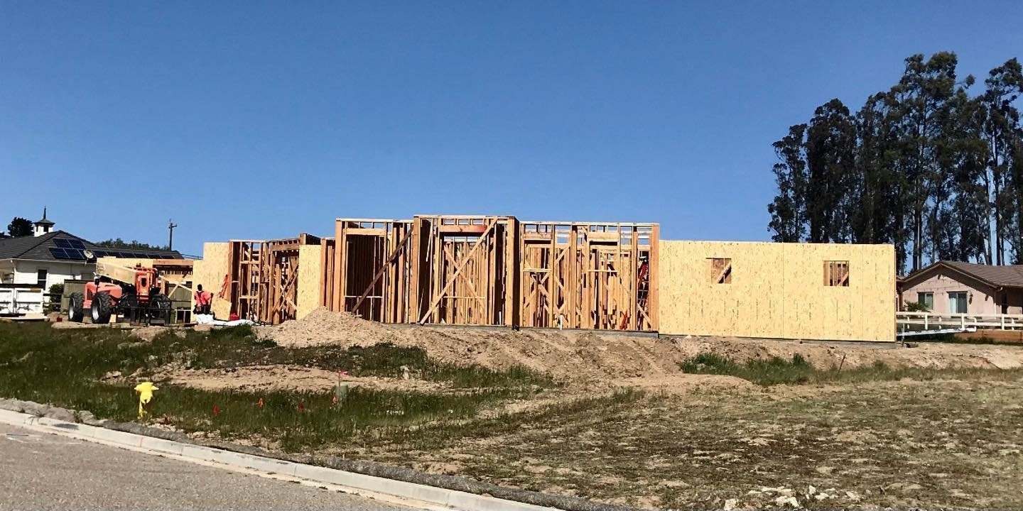 Before: house framing going up on a bare lot