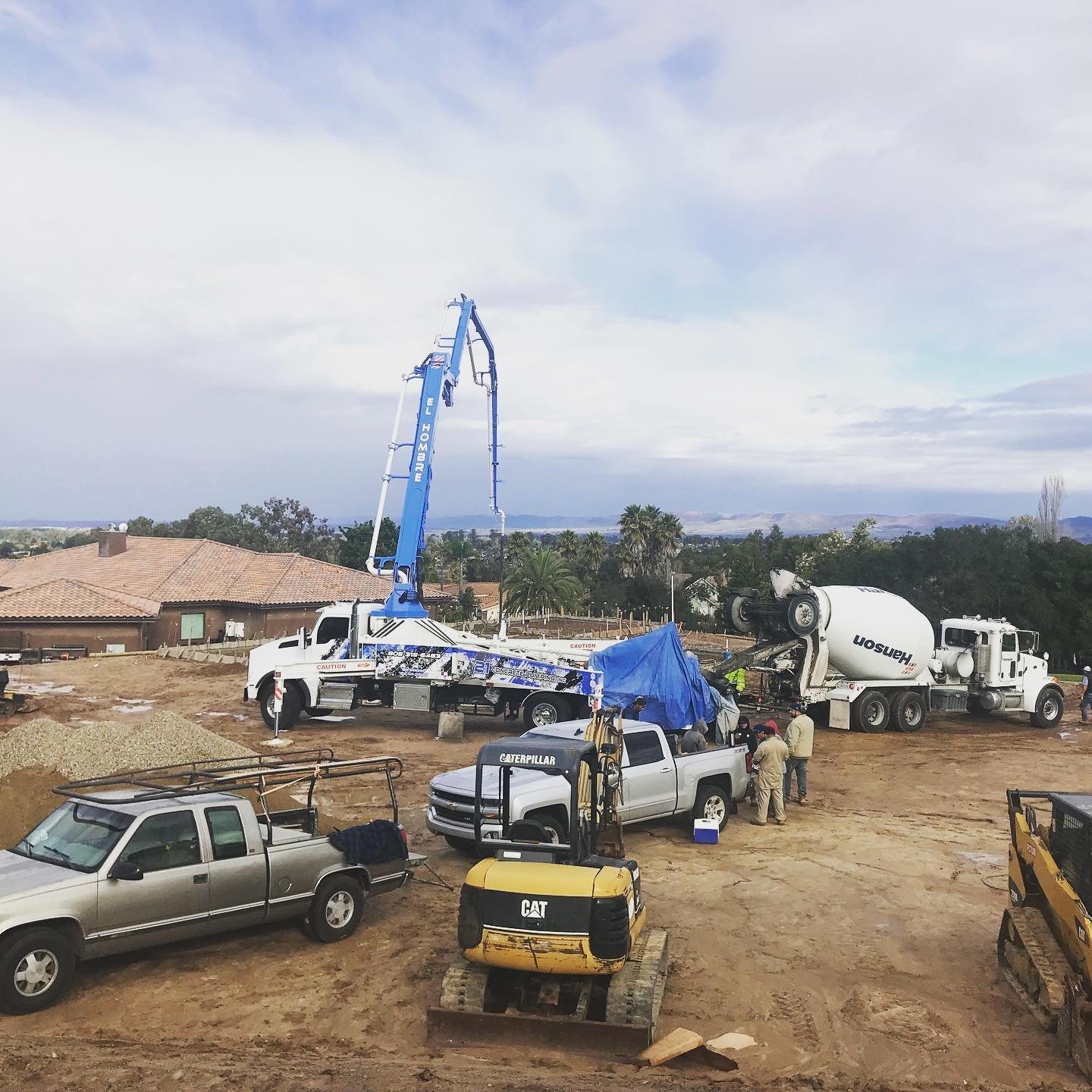 Concrete pump truck and crew at a residential construction site