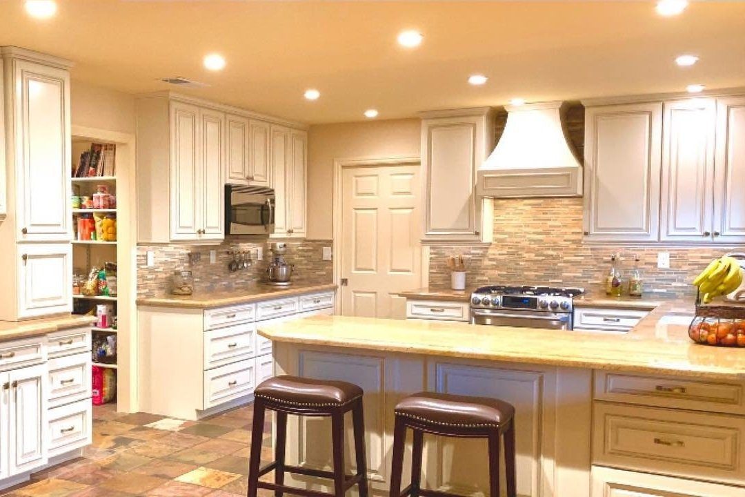 After: white cabinets, stone counters and a breakfast bar
