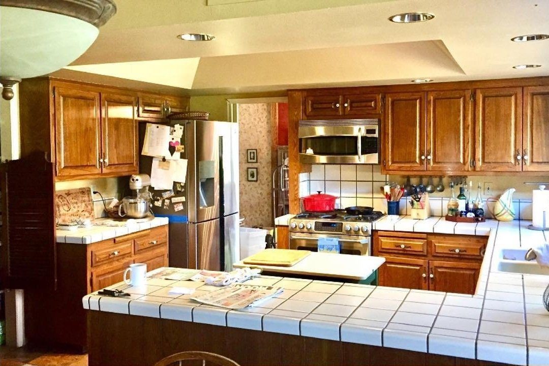 Before: dark wood cabinets and tiled counters